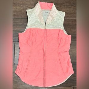 The North Face Women’s Vest Size Small Euc in a pretty pink/peach color.